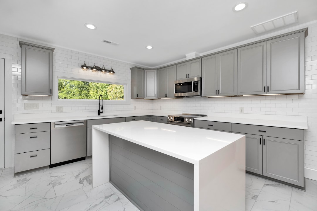 A modern kitchen countertop with minimal clutter, showcasing stylish decor and cleaning supplies.