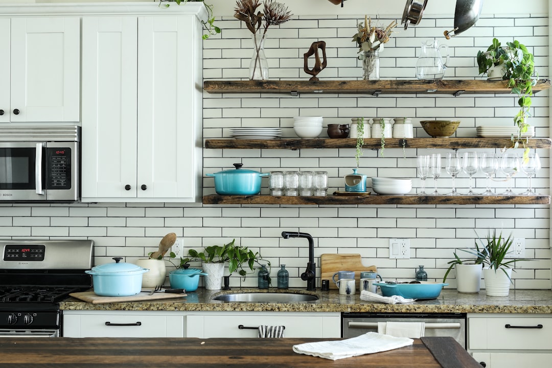 A bright and tidy kitchen with organized countertops and sparkling surfaces, showcasing simple cleaning habits in action.